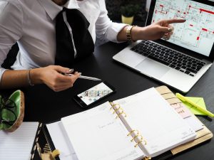 Businesswoman reviewing plans and managing her team