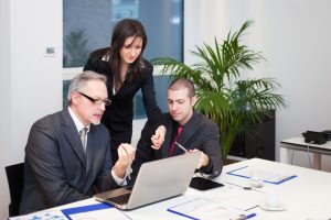 Manager reviewing data and leading his team during meeting